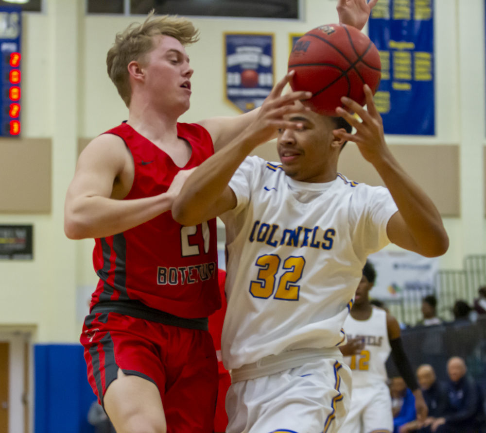 Lord Botetourt's (21) Luke Haale puts pressure on William Fleming's (32) Alexander Fuller.